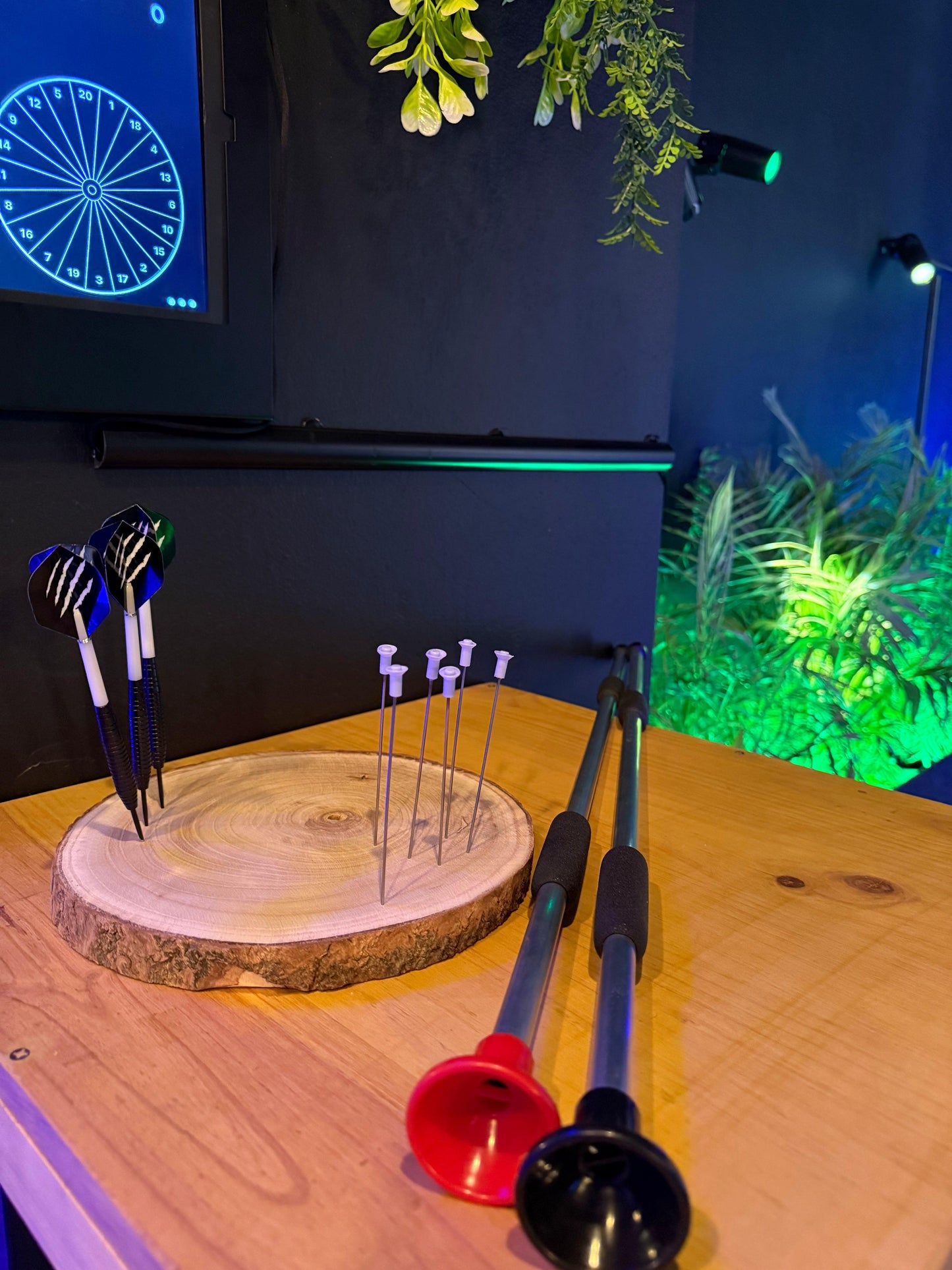 A group of friends playing interactive Pixels Darts, testing their accuracy with unique game modes in Playa Las Américas, Tenerife.