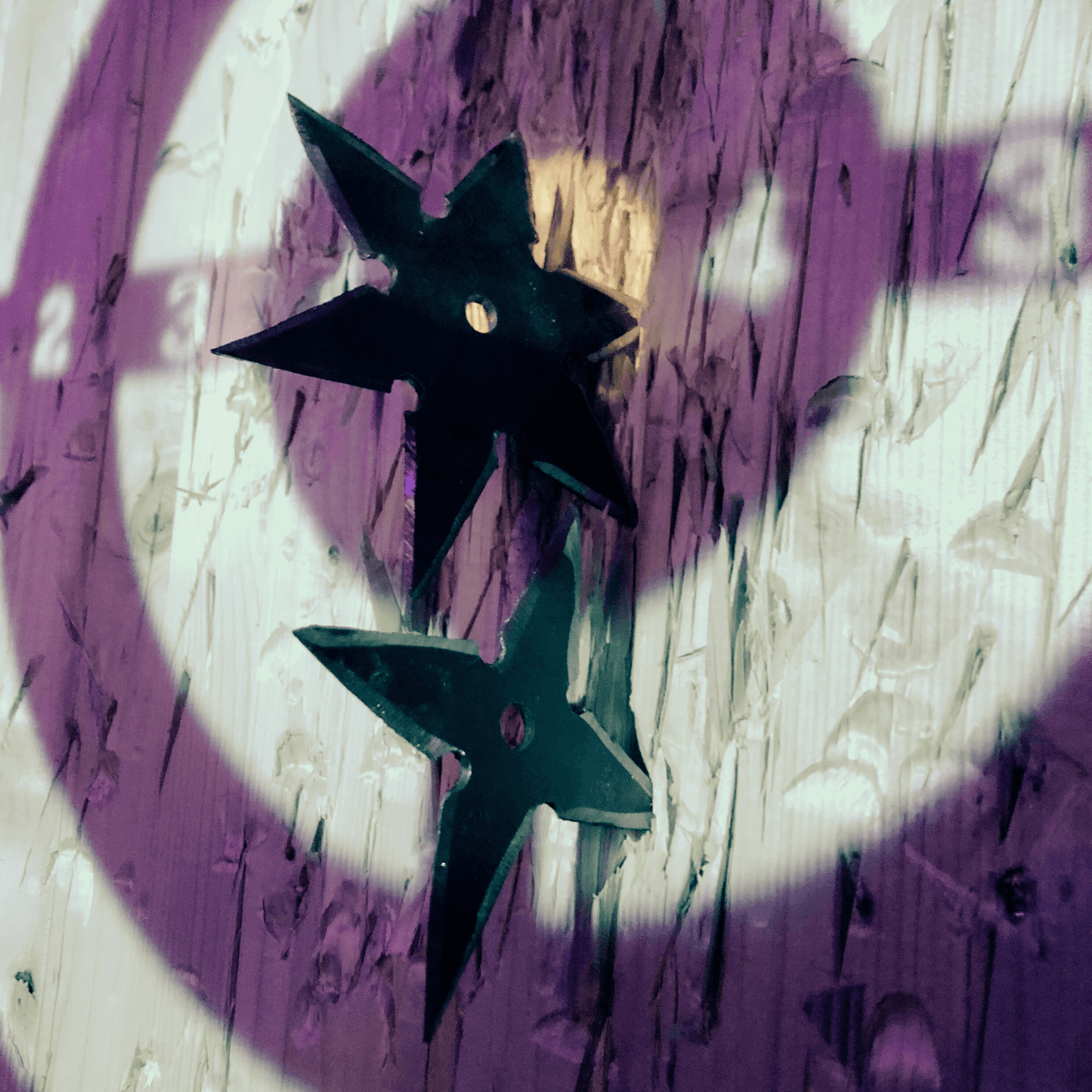 A birthday participant aiming at a target while throwing an axe and shuriken during a 2-hour celebration in Tenerife. The perfect adrenaline-filled party!