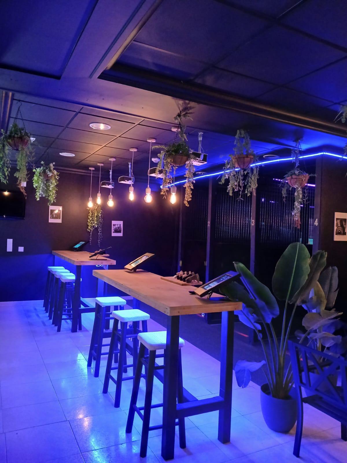 Indoor axe throwing arena with interactive targets, offering a unique and immersive experience in Playa Las Américas, Tenerife.