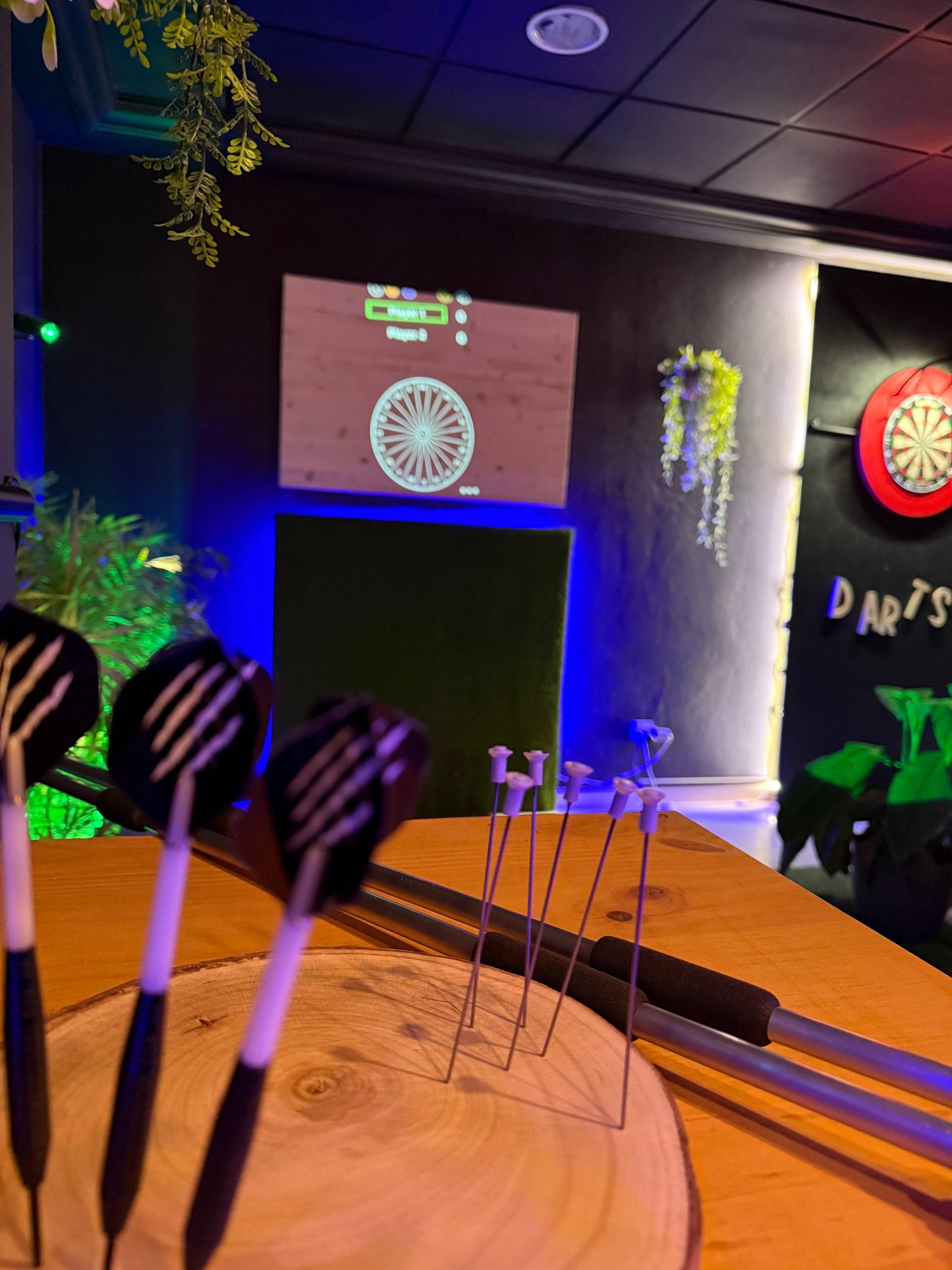 A participant enjoying a blowgun shooting challenge, an exciting addition to the Pixels Darts experience in Tenerife.